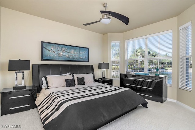 bedroom featuring ceiling fan and light carpet