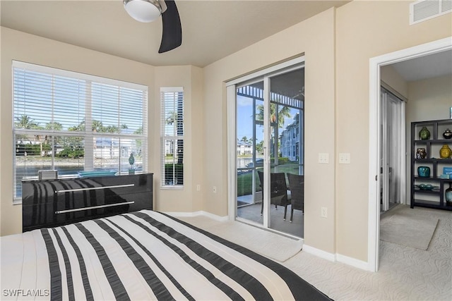 bedroom with light carpet, access to outside, and multiple windows