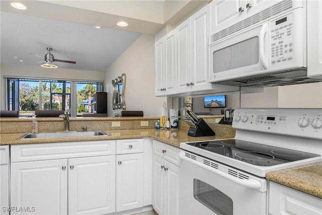 kitchen with white appliances, white cabinetry, ceiling fan, and sink