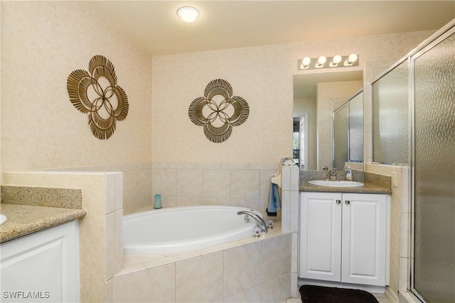 bathroom featuring vanity and plus walk in shower