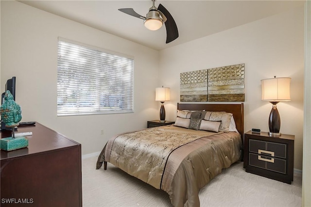 bedroom with ceiling fan and light colored carpet