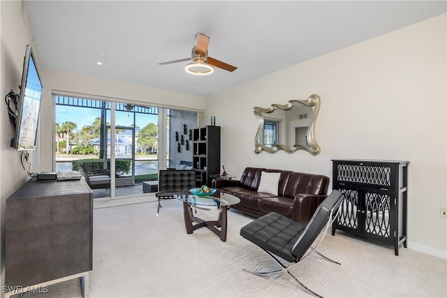 carpeted living room with ceiling fan