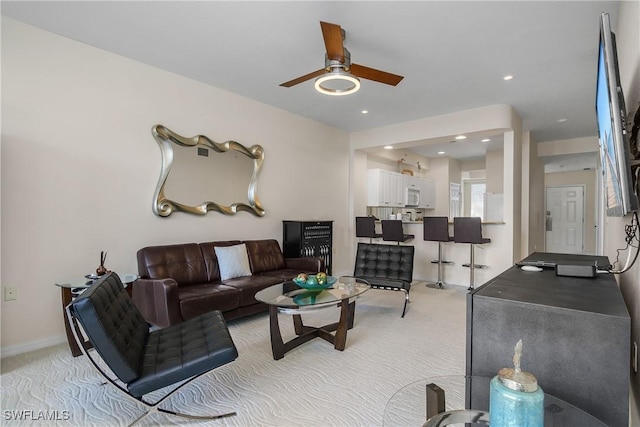 living room featuring ceiling fan and light carpet