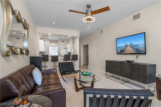 living room featuring ceiling fan and light colored carpet