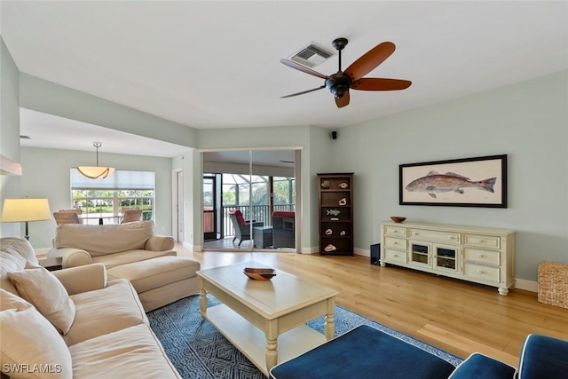 living room with hardwood / wood-style flooring and ceiling fan