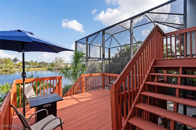 wooden deck featuring a lanai and a water view