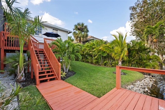 wooden deck featuring a yard