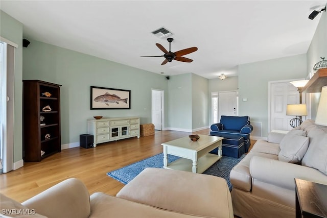 living room with light hardwood / wood-style floors and ceiling fan