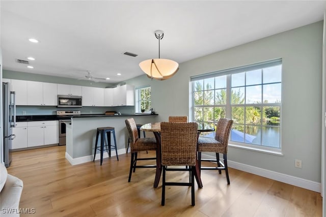 dining area featuring ceiling fan and light hardwood / wood-style flooring