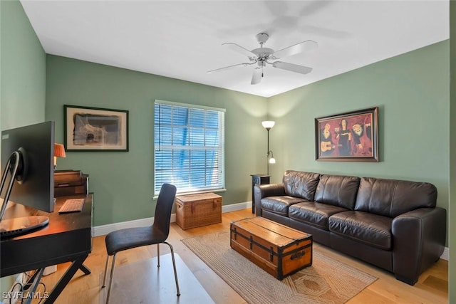 living room featuring ceiling fan and light hardwood / wood-style flooring