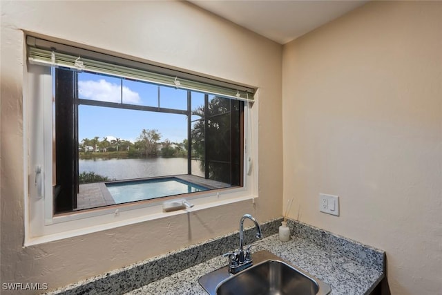 interior space featuring a water view and sink