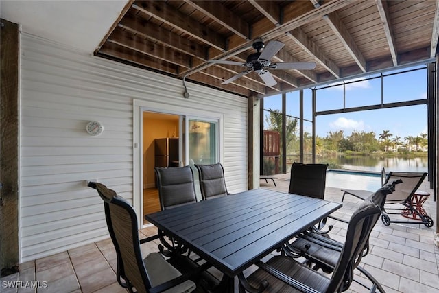 sunroom with ceiling fan, beamed ceiling, a water view, and wood ceiling