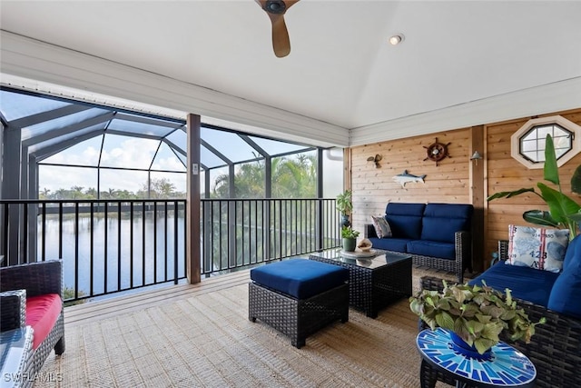 sunroom / solarium with a water view, ceiling fan, and lofted ceiling