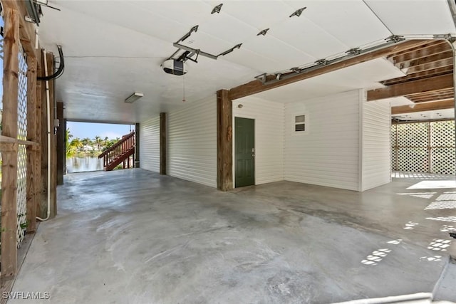 garage with a garage door opener and a carport