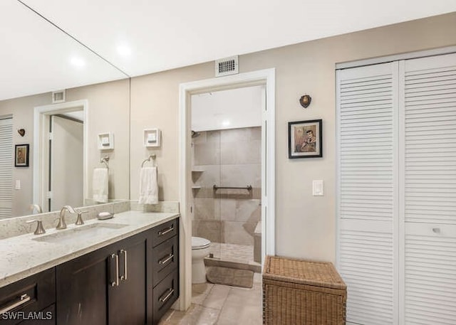 bathroom featuring tile patterned flooring, vanity, and toilet