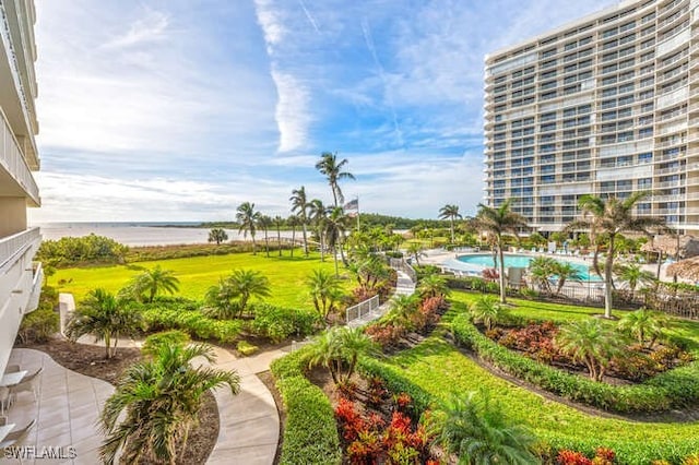 view of property's community featuring a pool and a water view