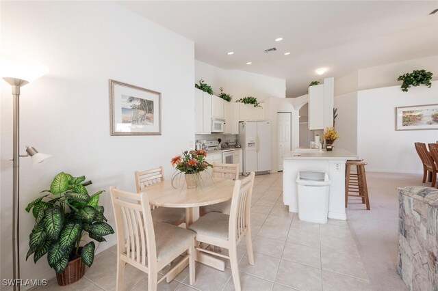 dining room featuring light colored carpet