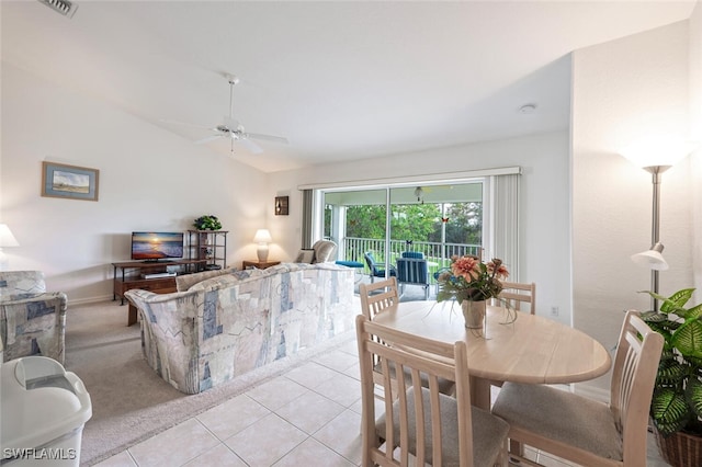 tiled dining area featuring ceiling fan and lofted ceiling