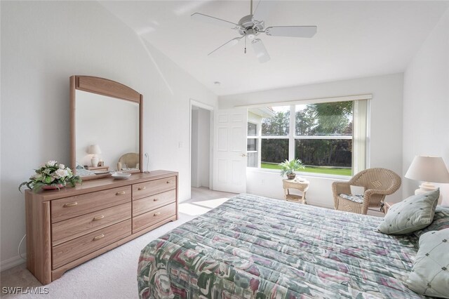 bedroom featuring light colored carpet, vaulted ceiling, and ceiling fan