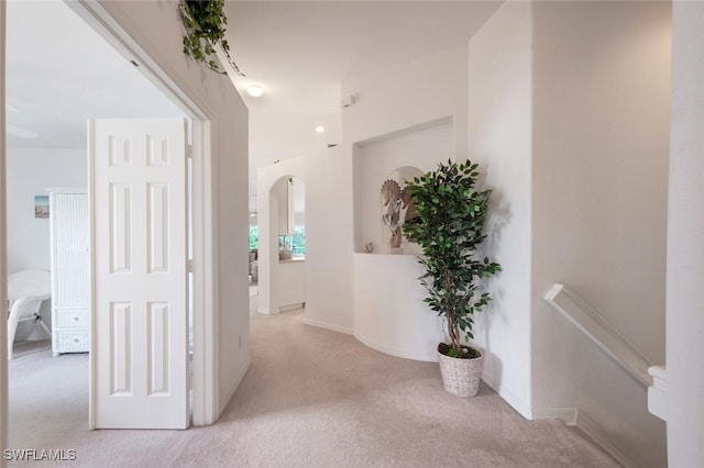 corridor featuring light colored carpet