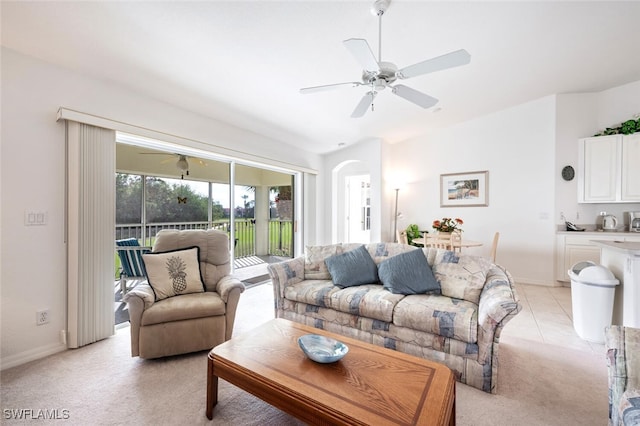 carpeted living room featuring ceiling fan