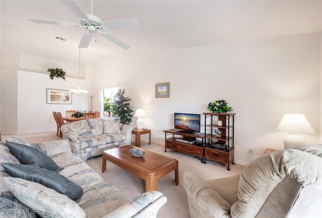 living room with light carpet and ceiling fan with notable chandelier