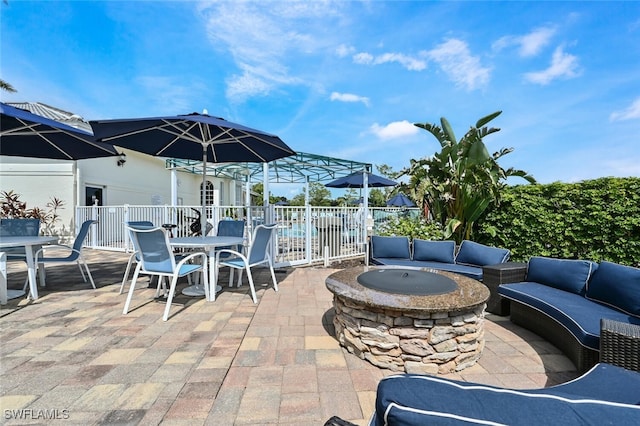 view of patio featuring an outdoor living space with a fire pit