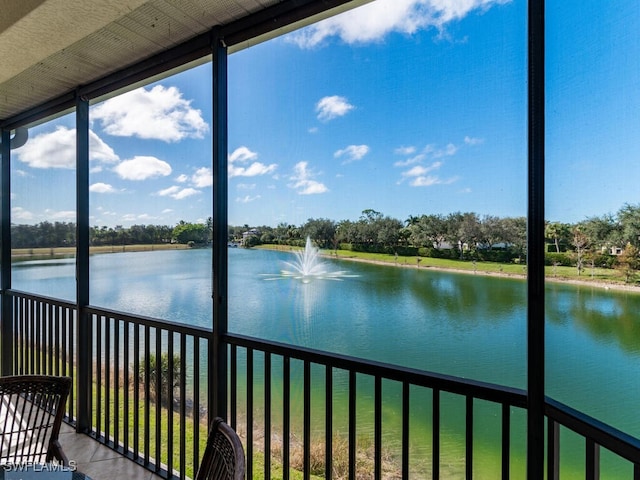 unfurnished sunroom featuring a water view