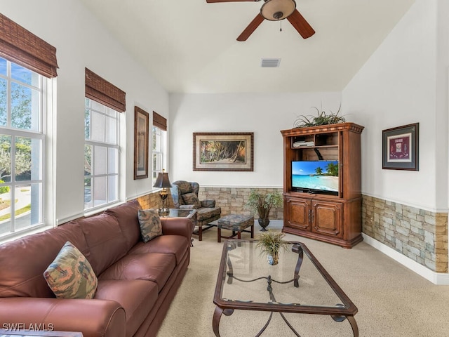 carpeted living room with ceiling fan and a wealth of natural light