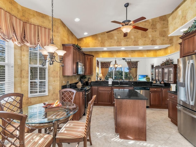 kitchen featuring plenty of natural light, a kitchen island, stainless steel appliances, and sink