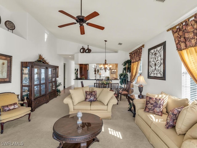 living room featuring ceiling fan with notable chandelier, light colored carpet, and high vaulted ceiling