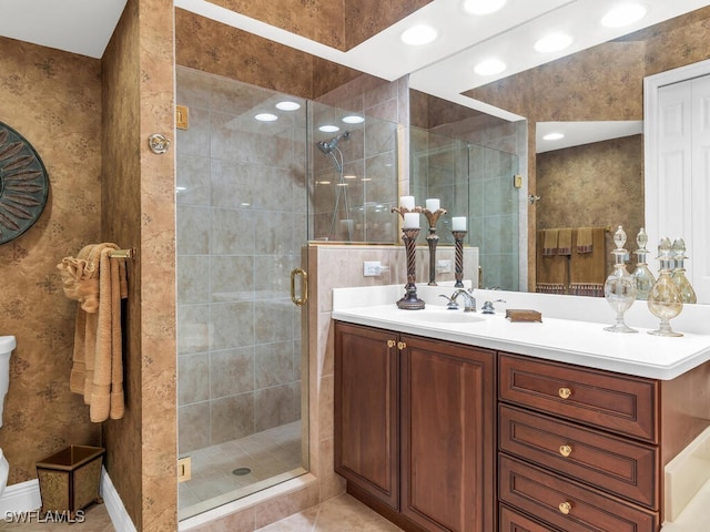 bathroom featuring tile patterned floors, vanity, and a shower with shower door