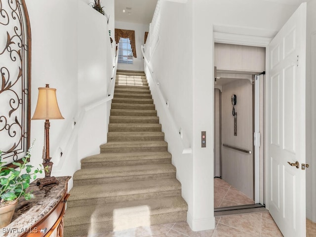 stairway with tile patterned floors