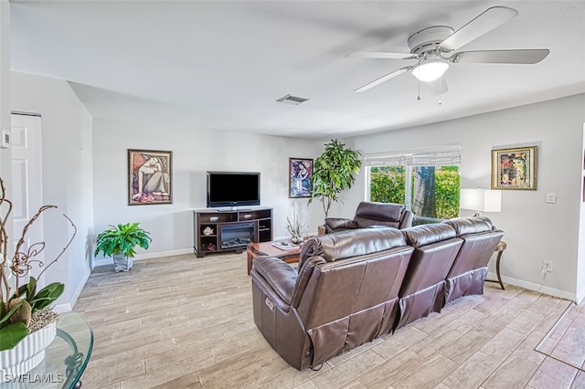 living room with ceiling fan and light wood-type flooring