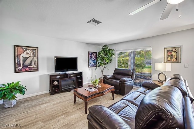 living room featuring light hardwood / wood-style flooring and ceiling fan