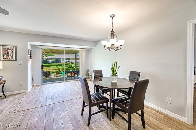 dining area featuring a notable chandelier and light hardwood / wood-style flooring