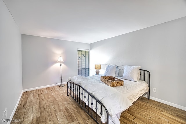 bedroom with hardwood / wood-style flooring