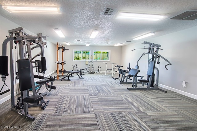 gym featuring carpet flooring and a textured ceiling