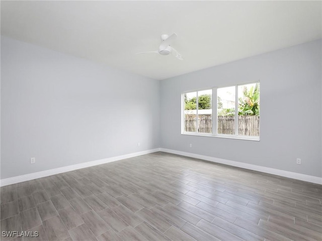 unfurnished room with ceiling fan and hardwood / wood-style floors