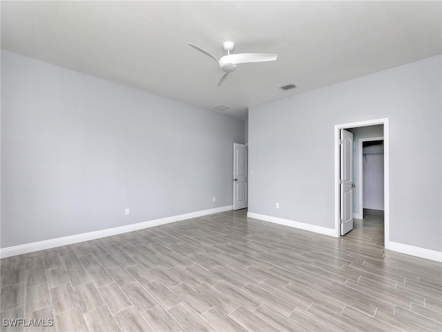 empty room featuring light hardwood / wood-style flooring and ceiling fan