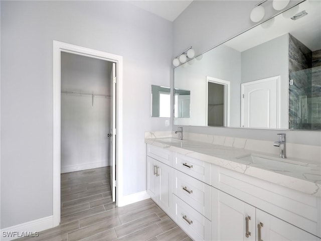 bathroom with vanity, hardwood / wood-style flooring, and walk in shower