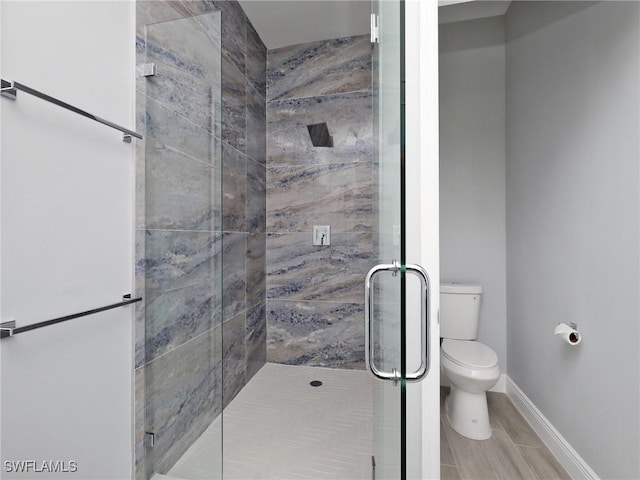 bathroom featuring toilet and walk in shower