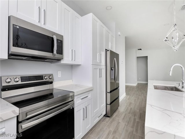 kitchen with white cabinets, appliances with stainless steel finishes, and sink