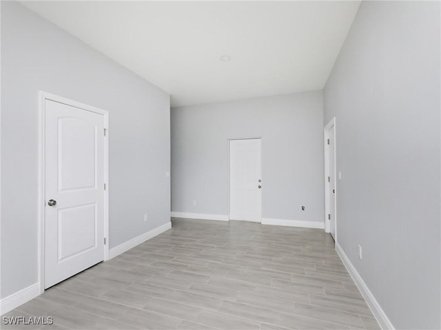 unfurnished room with light wood-type flooring