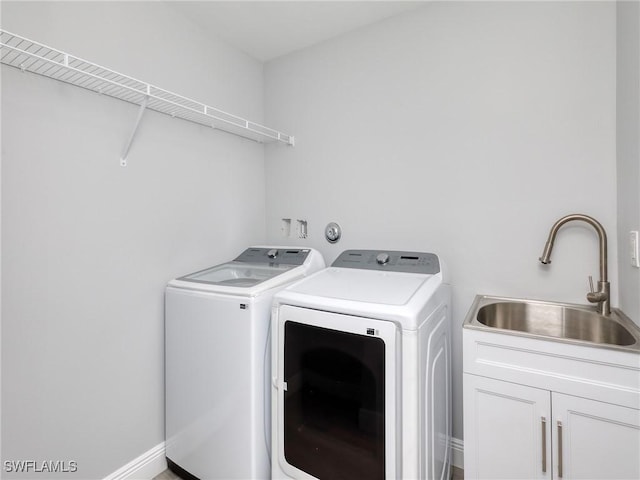 laundry room with sink, cabinets, and independent washer and dryer