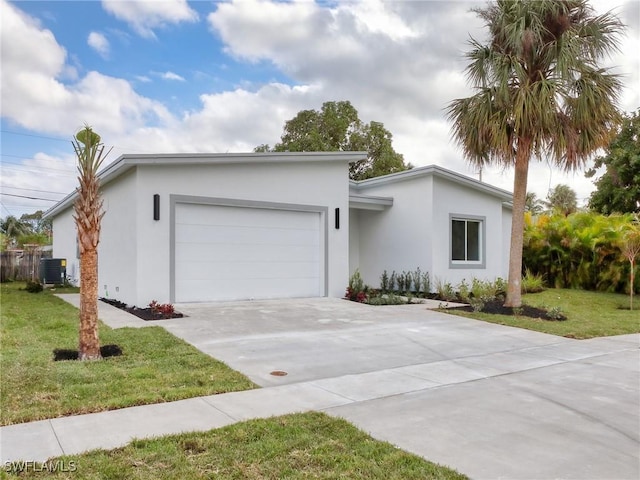 ranch-style house with central AC unit, a garage, and a front lawn