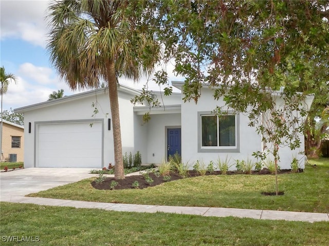 view of front of property with a garage, a front yard, and central AC