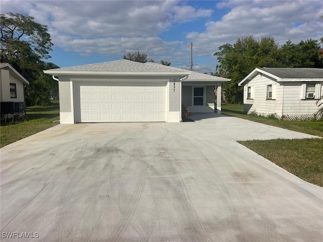 ranch-style house with a garage and a front lawn