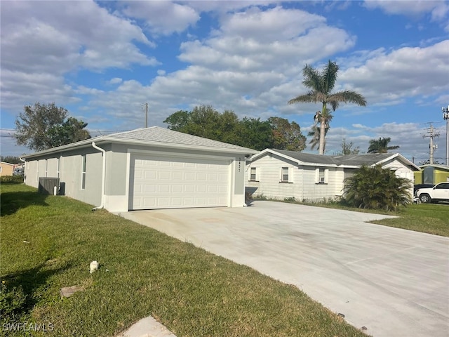 view of side of property with a lawn and a garage