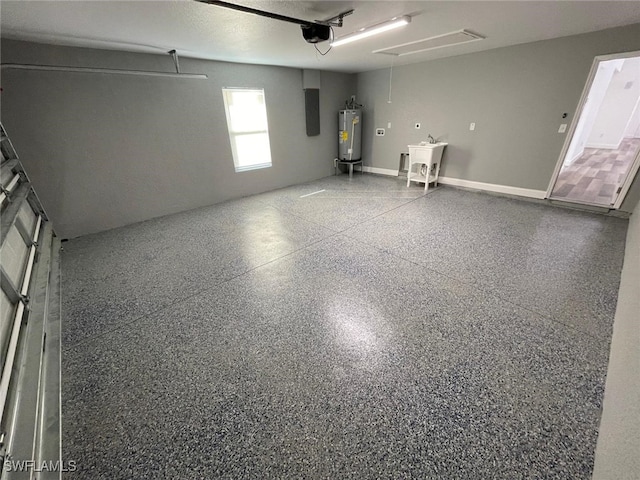 garage featuring gas water heater, sink, and a garage door opener